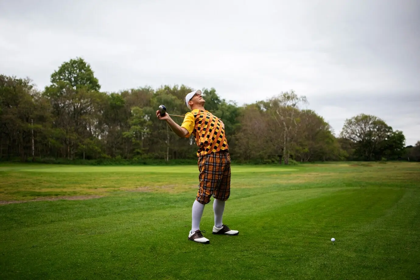Man playing golf outdoors