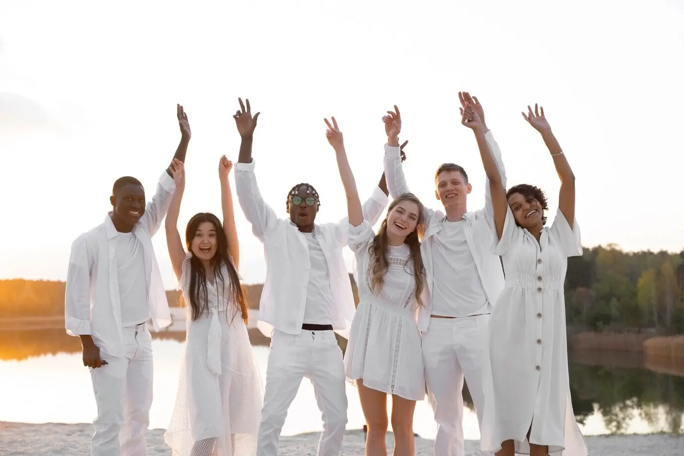 Medium shot of happy friends posing on a beach.